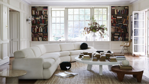 designer living room with featured white sofa and round coffee table