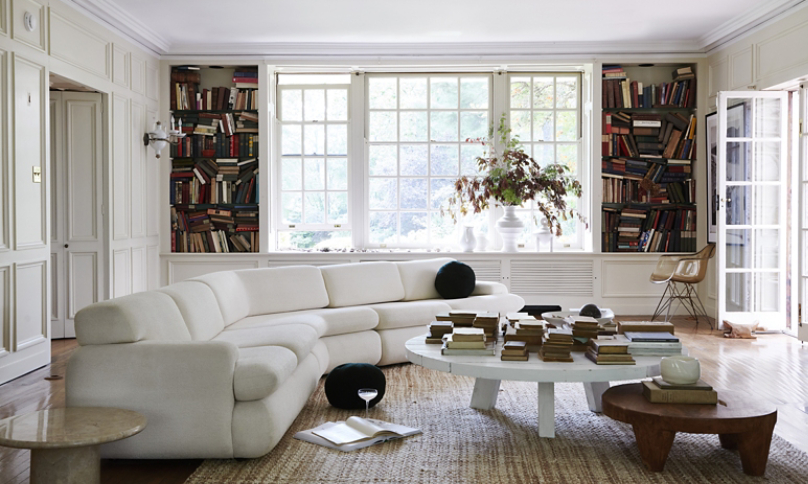 designer living room with featured white sofa and round coffee table