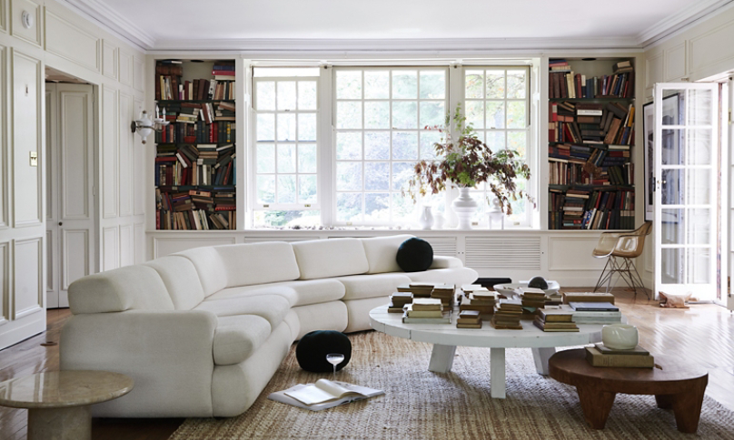 designer living room with featured white sofa and round coffee table