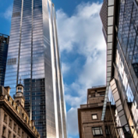 The image showcases a city scene where tall, reflective skyscrapers tower above a historic building, highlighting the intersection of modern innovation and classic architecture  in London UK