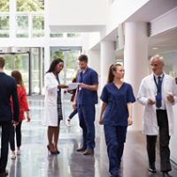 Staff In Busy Lobby Area Of Modern Hospital
