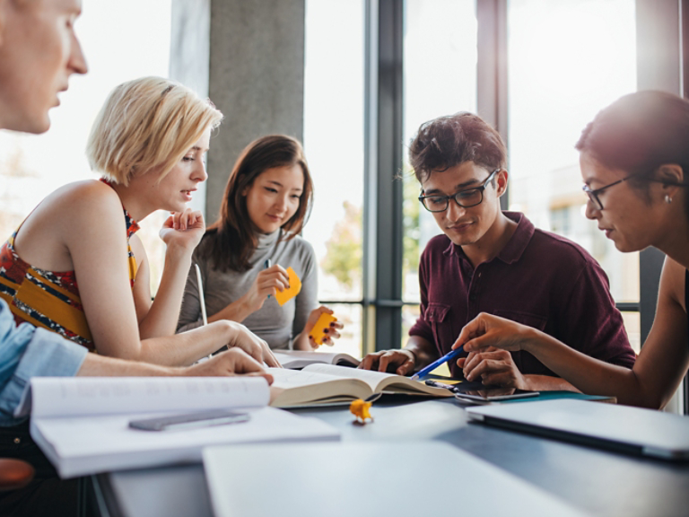 Diverse group of students studying at library