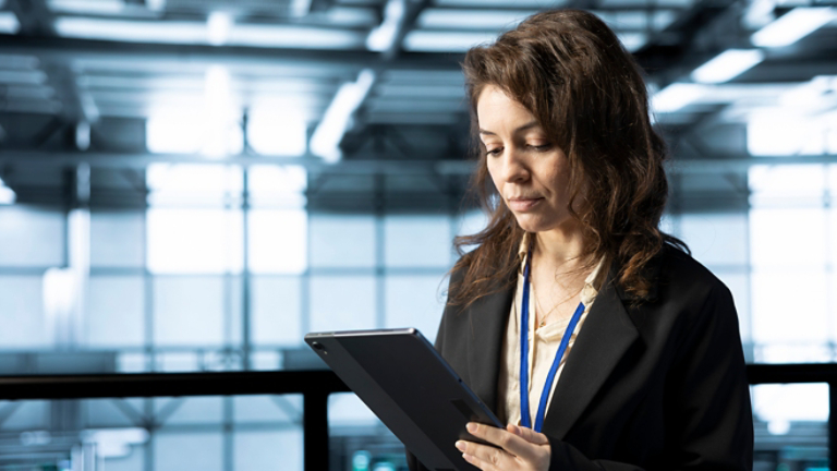 Technician in data center using tablet, integrating green technologies