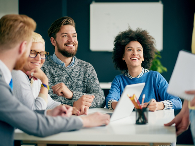 Multi ethnic team having presentation/ meeting in modern office