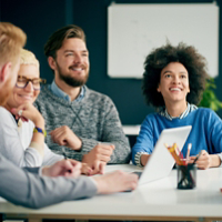 Multi ethnic team having presentation/ meeting in modern office