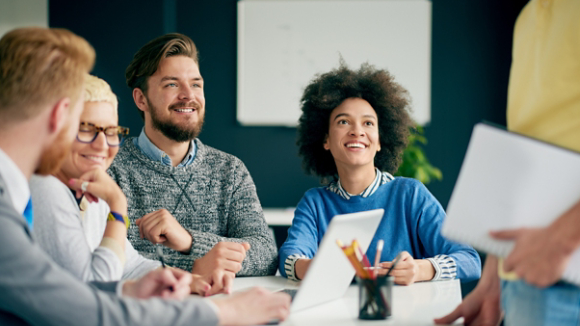 Multi ethnic team having presentation/ meeting in modern office