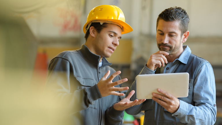 boss and worker checking results on the tablet