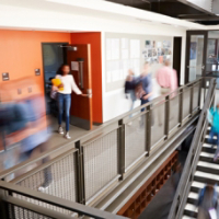 Busy High School Corridor During Recess With Blurred Students And Staff
