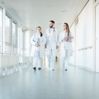 Doctors, two women and a man, in hospital