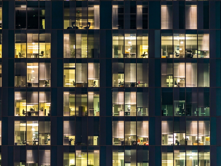 window of the multi-storey building of glass and steel lighting and people within timelapse