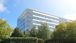 modern office building stands among lush green trees