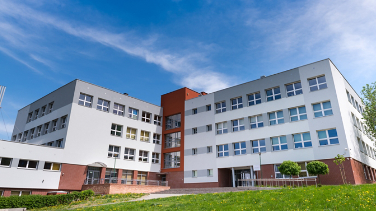 Public school building at sunny day, exterior view