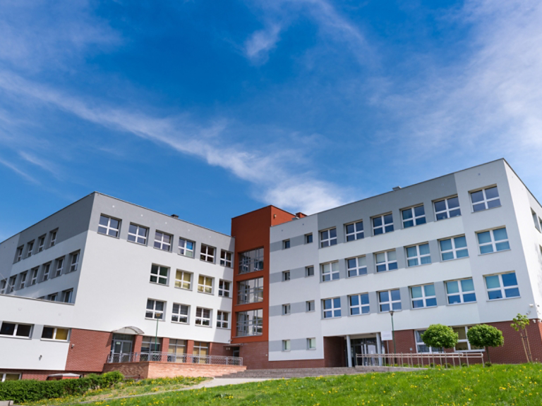 Public school building at sunny day, exterior view
