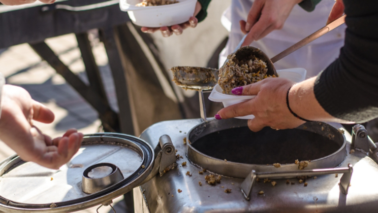 preparing a meal in the kitchen of field and feeds people on the street.