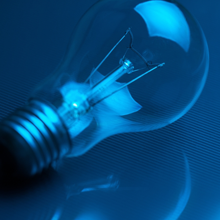 Photo of light bulb lamp in neon light. 