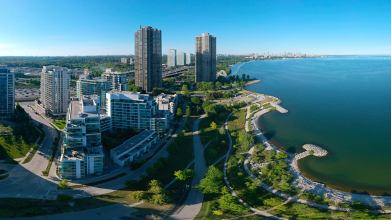 Artistic creative view of Humber Bay Shores Park city view and green space with skyline cityscape, azure lake Ontario. Skyscrapers over The Queensway on sunset at summer, Etobicoke, Ontario, Canada