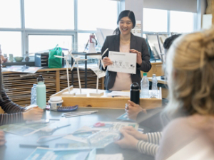 Female high school teacher discussing wind turbines with students
