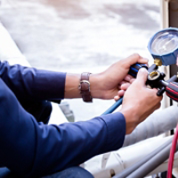 Technician is checking air conditioner ,measuring equipment for filling air conditioners.