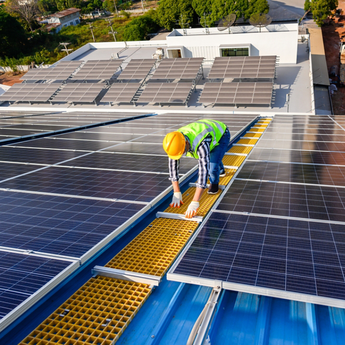 Engineers are examining solar panels in an installation at a power plant where solar panels are installed using solar energy.