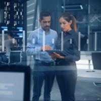 Female and Male Engineers Analyzing Data on Futuristic Transparent Touch Screen. Developers and Engineers Working in High Tech Research Lab with Data Servers using Computers showing Data and Graphs.