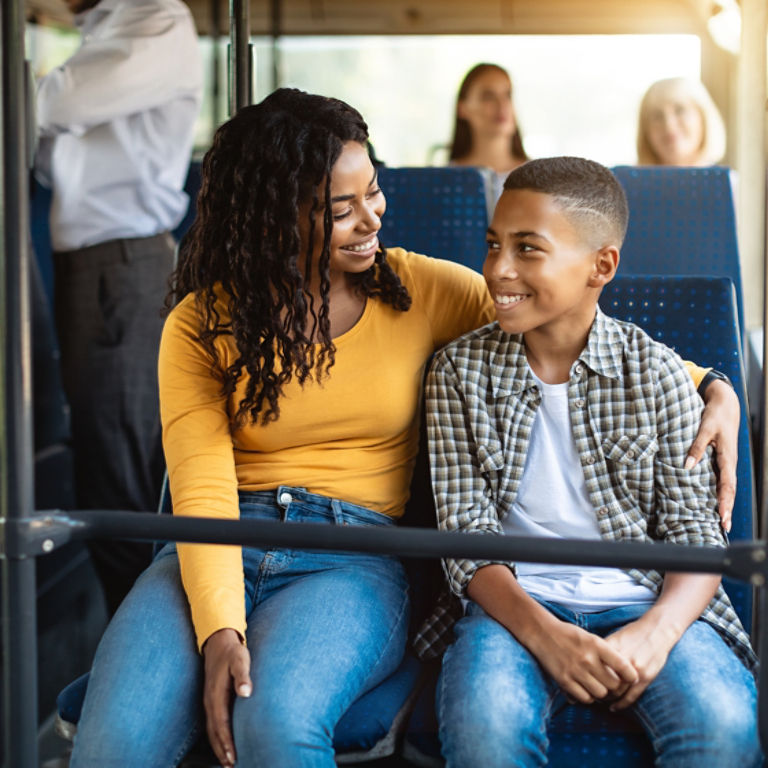 Beautiful smiling African American family going on a bus