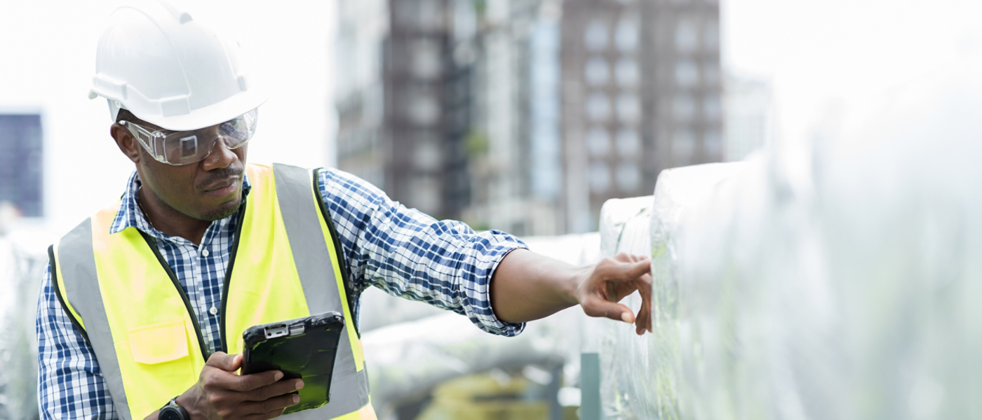 Male engineer checking or maintenance pipe system for ventilation and air conditioning on rooftop of building