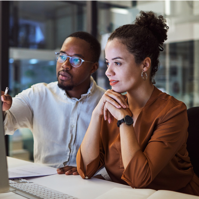 Colleagues collaborating at modern office desk