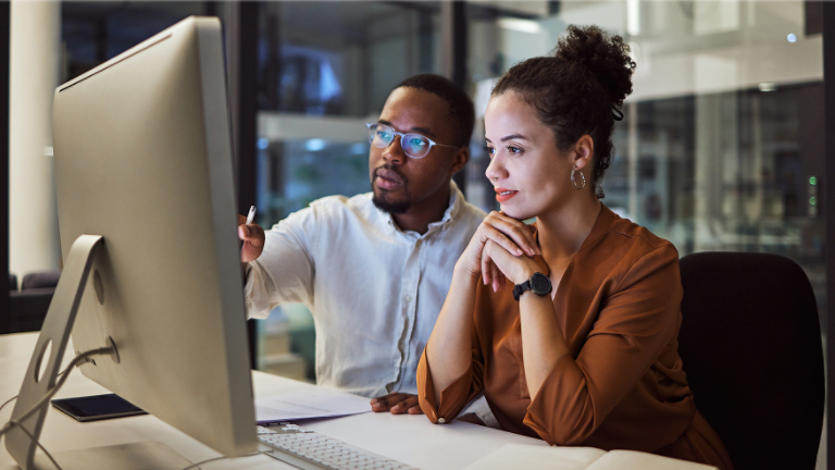 Two people looking at a computer
