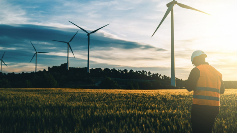 Engineer working at alternative renewable wind energy farm - Sustainable friendly industry concept
