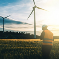 Engineer working at alternative renewable wind energy farm - Sustainable friendly industry concept