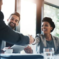 Happy business people, handshake and meeting in teamwork for partnership or collaboration in boardroom. Woman person shaking hands in team recruiting, introduction or b2b agreement at the workplace