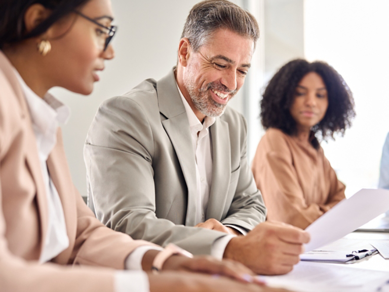 Happy business man checking law document at legal advice meeting.