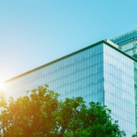 Environmentally friendly office building a sustainable glass building with trees reduces heat and carbon dioxide. Office buildings with a green environment save energy and allow employees to relax.