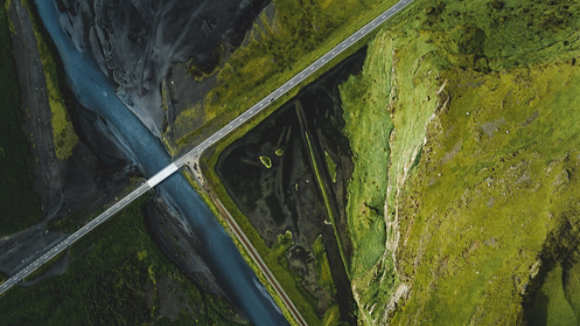 Road cutting through green hills