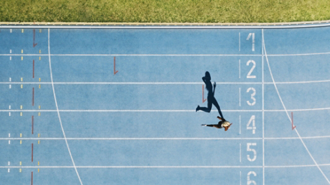Track and field track with sprinter in overhead shot