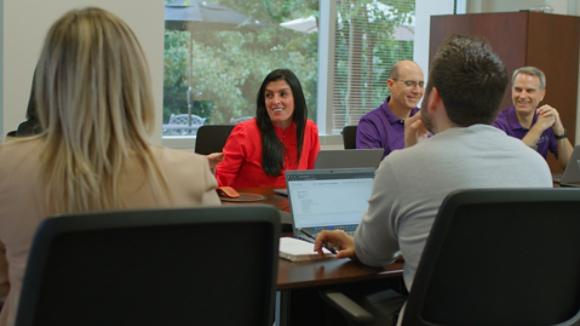 Alessandra Hammond leading her team in a brainstorming session