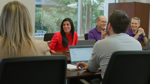 Alessandra Hammond leading her team in a brainstorming session