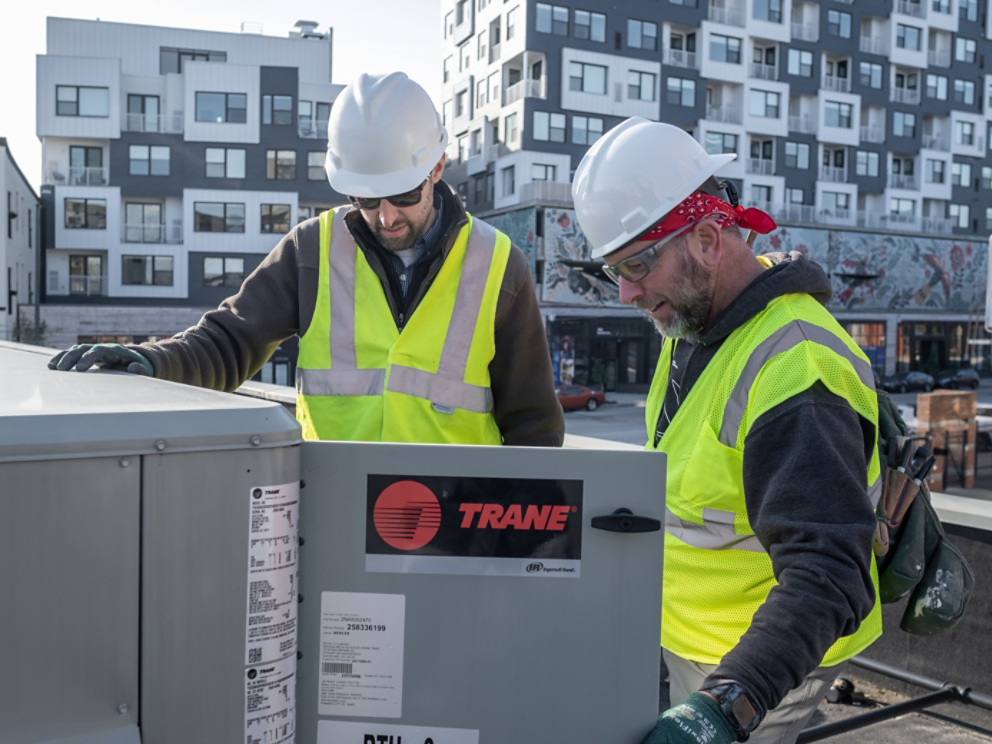 Trane Technicians working on an HVAC rooftop unit.