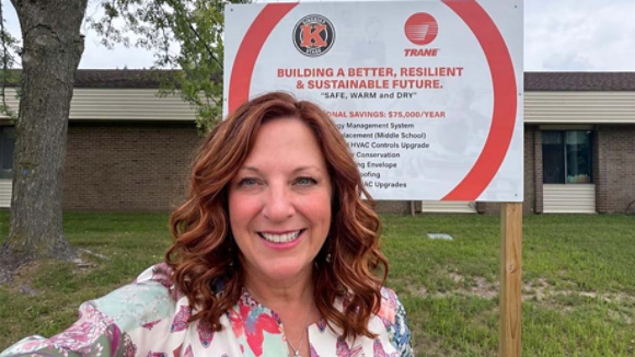 Gwen Pettit in front of sustainability project sign