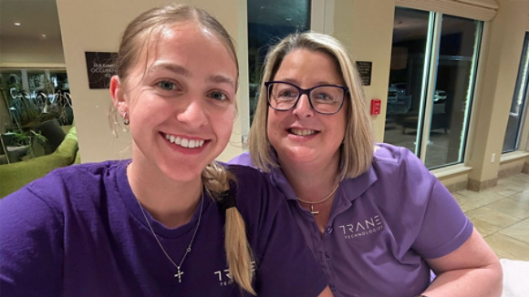 Jennifer and her daughter wearing purple Trane Technologies shirts