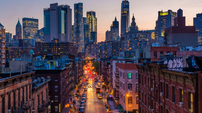 View of Madison Street and Lower Manhattan at sunset from the Manhattan Bridge in New York City