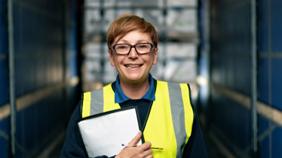 Female employee smiling in empty trailer 2