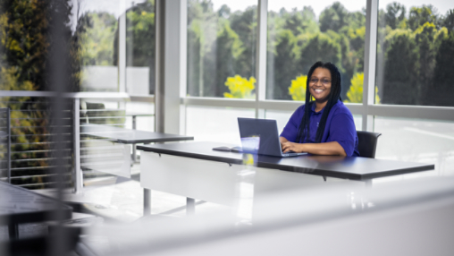 Davidson woman happily working at desk