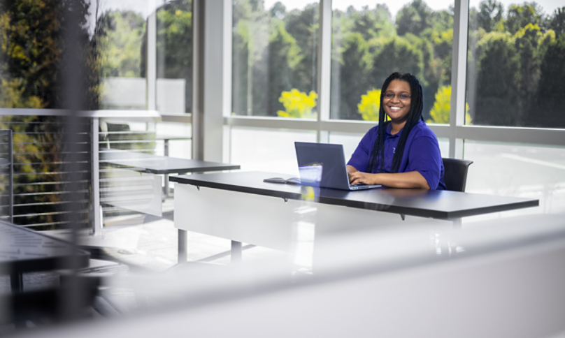 Davidson woman happily working at desk