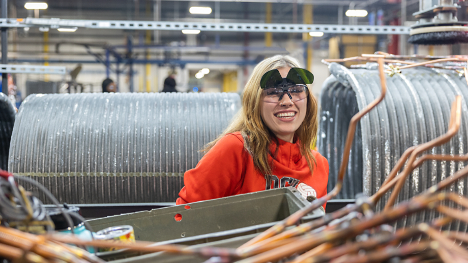 Female employee surrounded by unit components