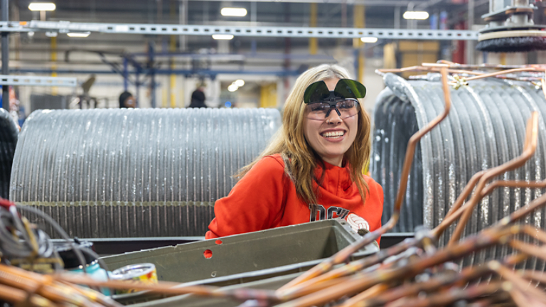Female employee surrounded by unit components