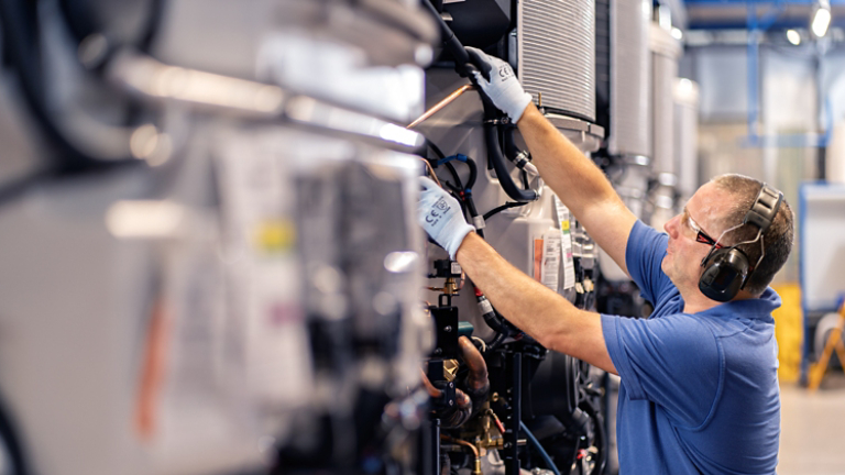 Male employee assembling large unit 3