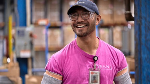 Male employee smiling in plant