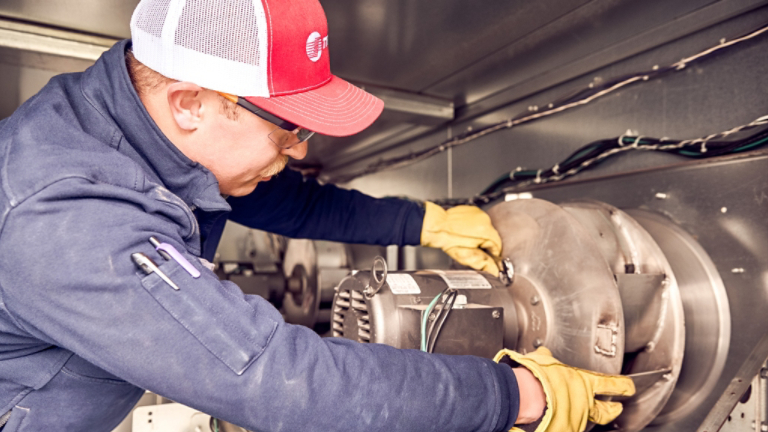 Technician working inside unit