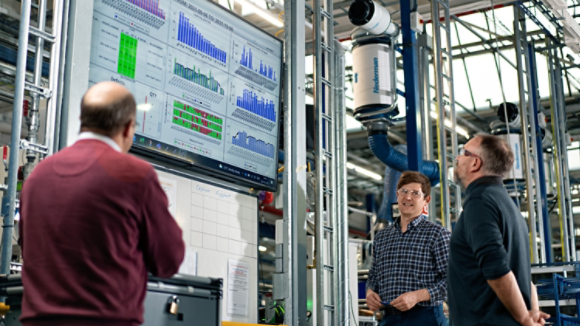 Male coworkers reviewing MDI board